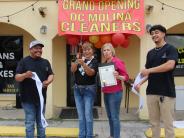 DC Molina Cleaners Owners with Mayor Riley cutting the ribbon for opening ceremony event