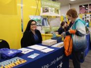 RBFCU employee smiling at EWL day event booth sharing financial support