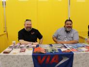 VIA booth with two male representatives sharing transportation information