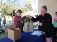 image of woman receiving a tree at EWL day event