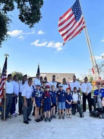 American Legion members along with Boy Scout Troop with large American flag at Flag Day in Leon Valley