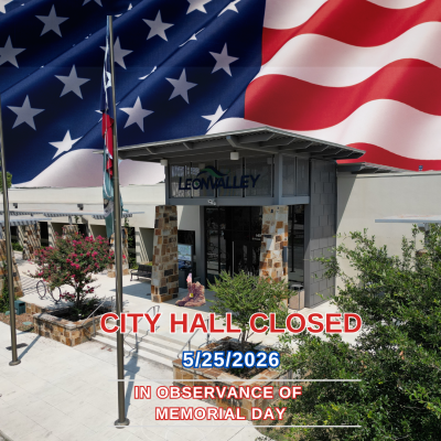 image of City Hall building entrance with waving flag as sky background for Memorial Day closure notice