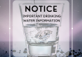 Image of water poured into a clear medium glass sharing a drinking water notice